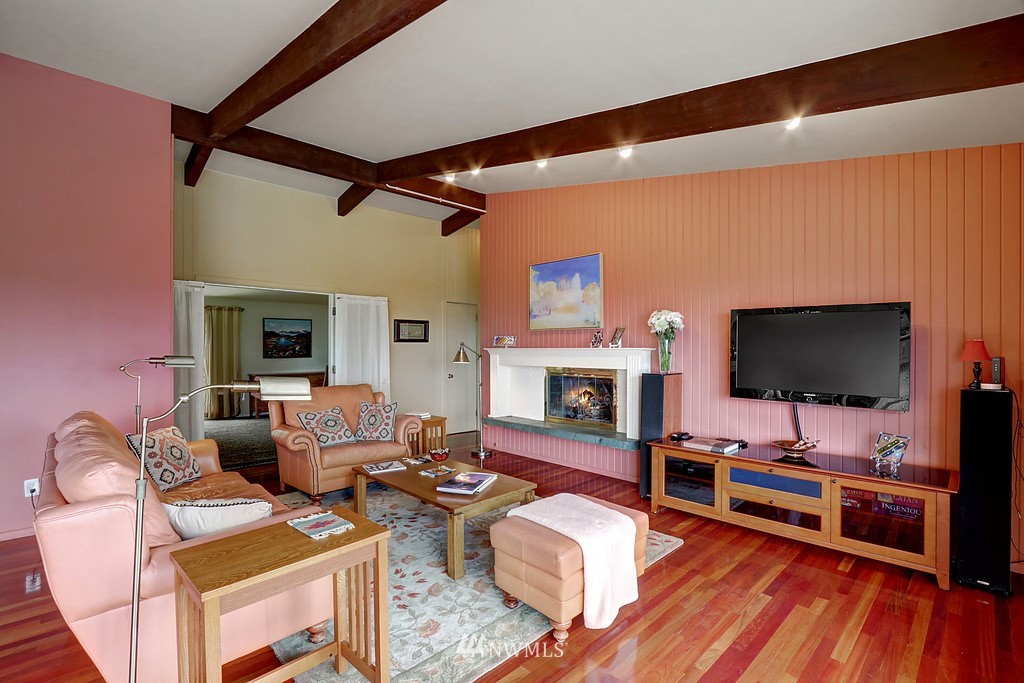 1031 C Avenue South Edmonds, WA 98020 - Photo 7 of 25 a living room with furniture a flat screen tv and a fireplace