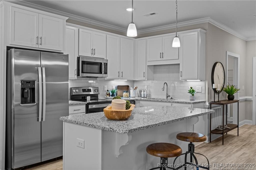 200 Gallery Drive, Unit 301 Spring Lake, NC 28390 - Photo 11 of 21 a kitchen with stainless steel appliances granite countertop a sink a stove a refrigerator cabinets and chairs