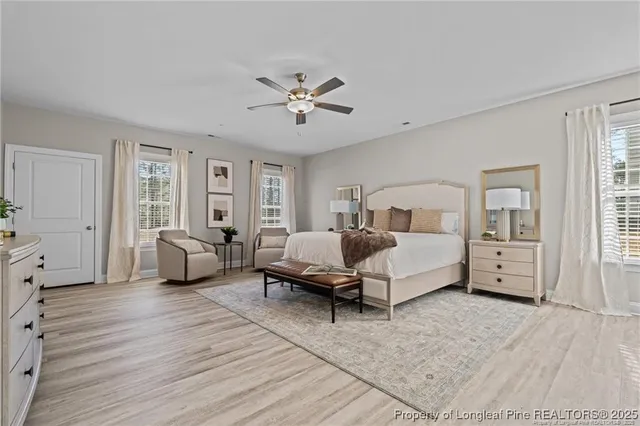 a spacious bedroom with a bed couch and a window