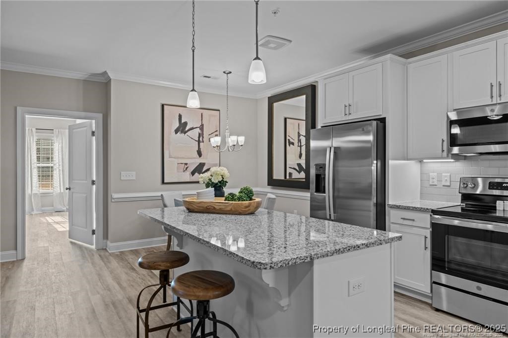 200 Gallery Drive, Unit 301 Spring Lake, NC 28390 - Photo 5 of 21 a kitchen with stainless steel appliances granite countertop a sink a stove a refrigerator cabinets and dining table