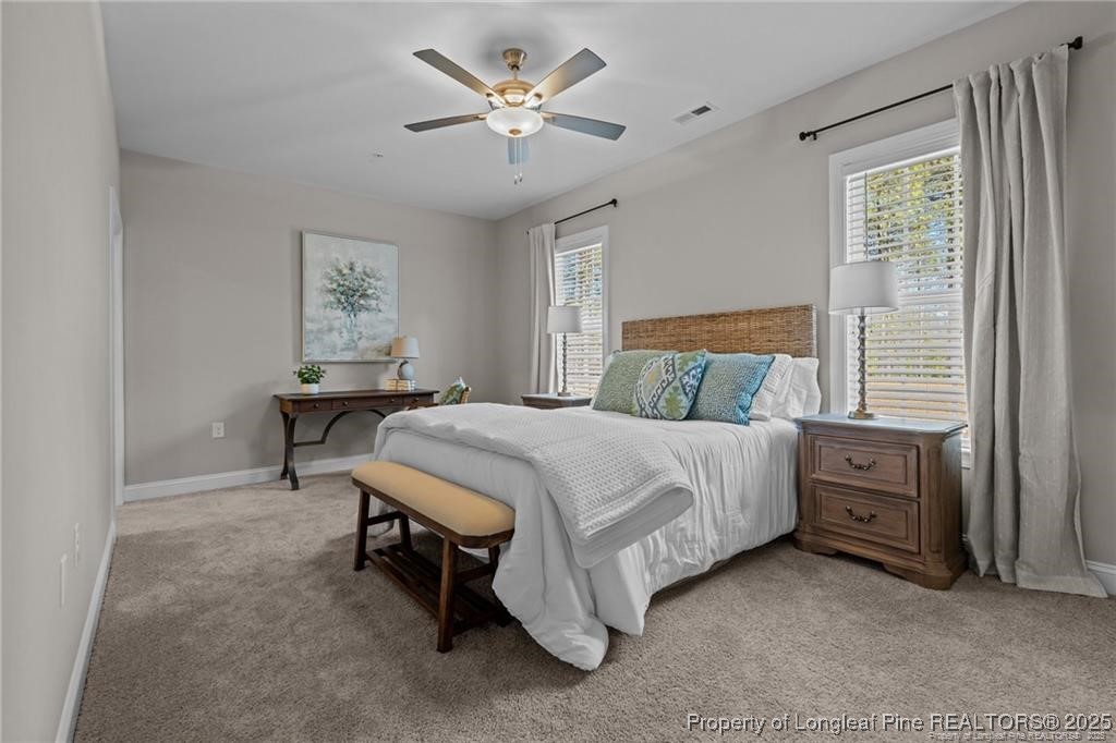 200 Gallery Drive, Unit 301 Spring Lake, NC 28390 - Photo 6 of 21 a bedroom with a bed and a chandelier