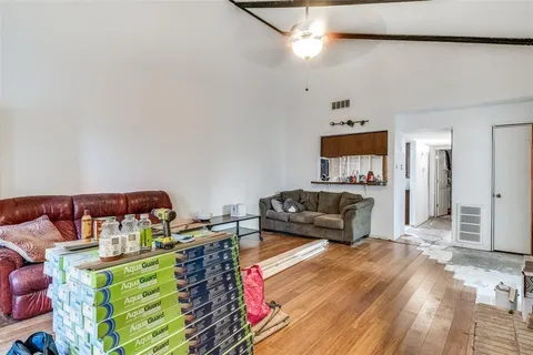 a bedroom with furniture and a wooden floor