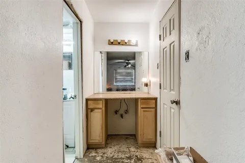 a bathroom with a granite countertop sink a mirror and a bathtub