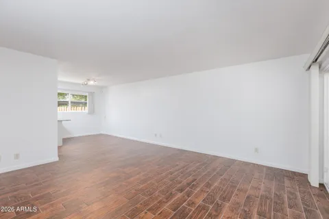 an empty room with a windows and closet