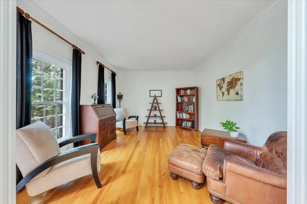 a view of a house with backyard and a tree