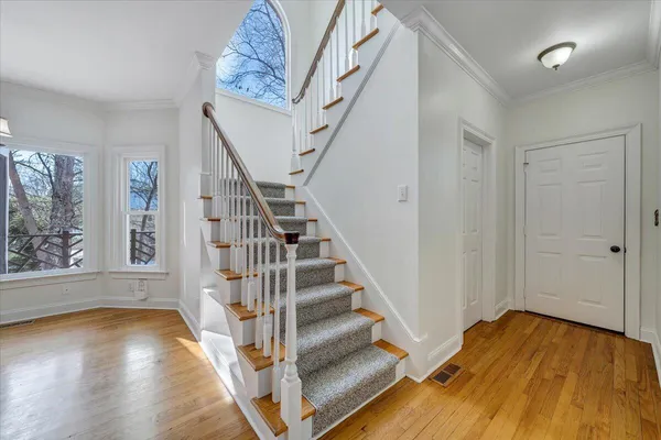 a spacious bathroom with a granite countertop sink a mirror and a shower