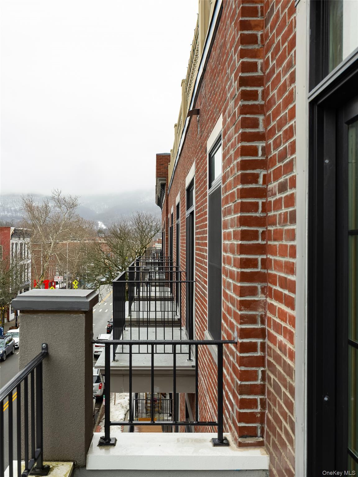 249 Main Street, Unit 312 Beacon, NY 12508 - Photo 3 of 23 a view of a building from a balcony