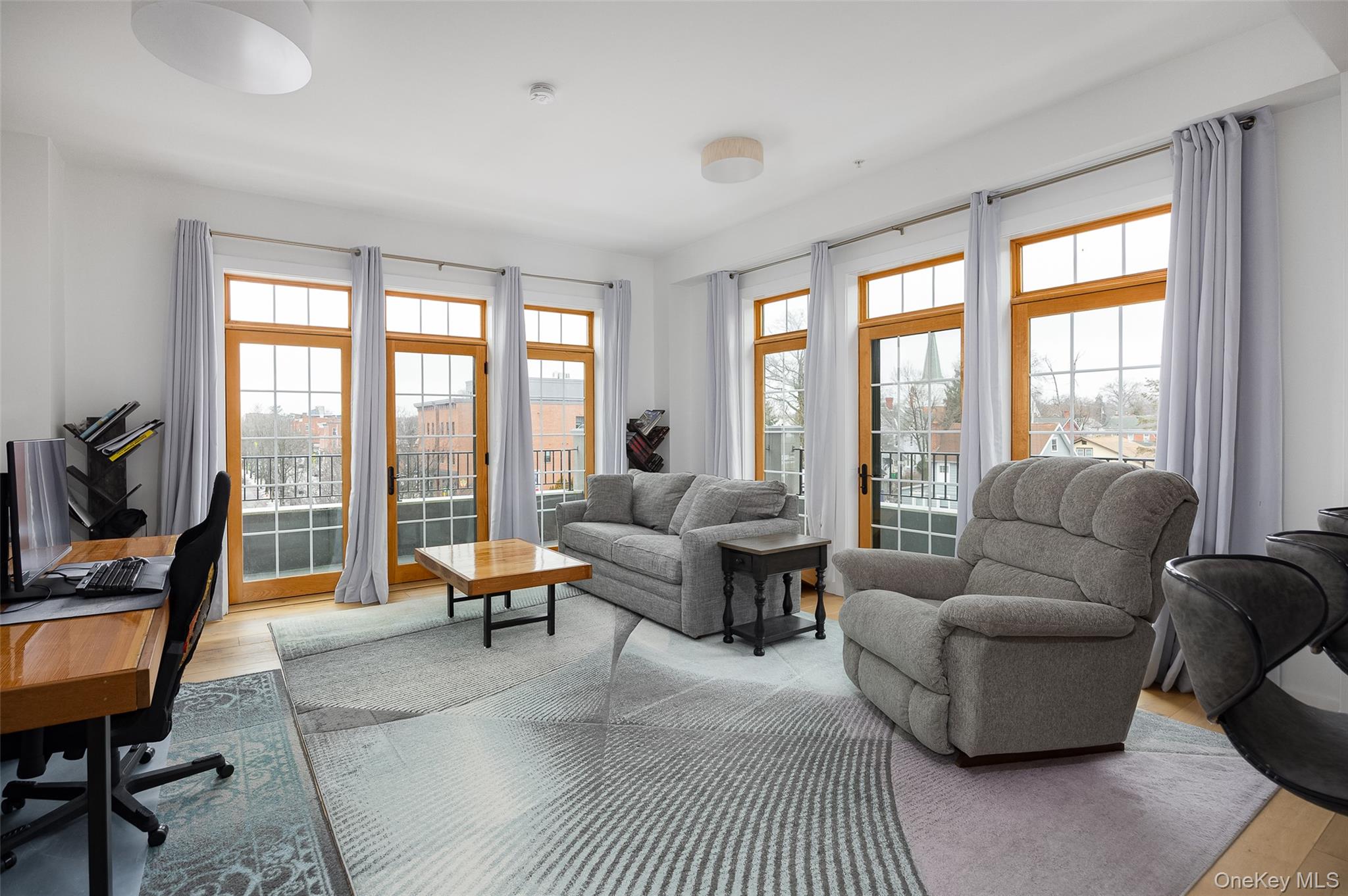 249 Main Street, Unit 312 Beacon, NY 12508 - Photo 5 of 23 a living room with furniture and a large window