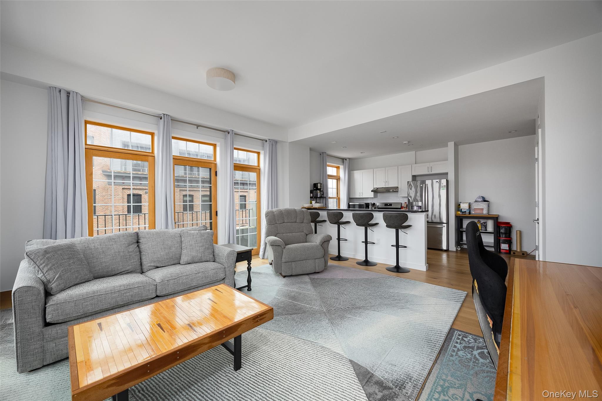 249 Main Street, Unit 312 Beacon, NY 12508 - Photo 6 of 23 a living room with furniture and a large window