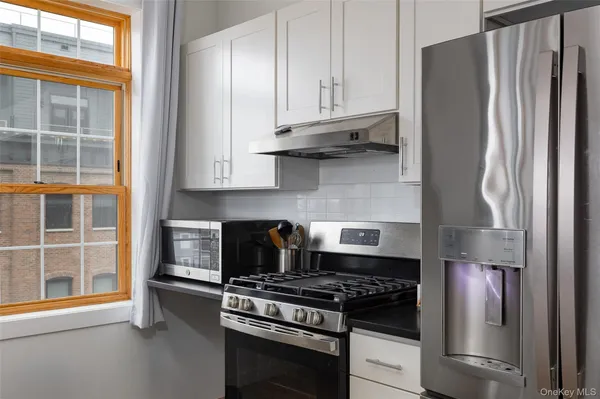 a kitchen with stainless steel appliances granite countertop a stove and a refrigerator