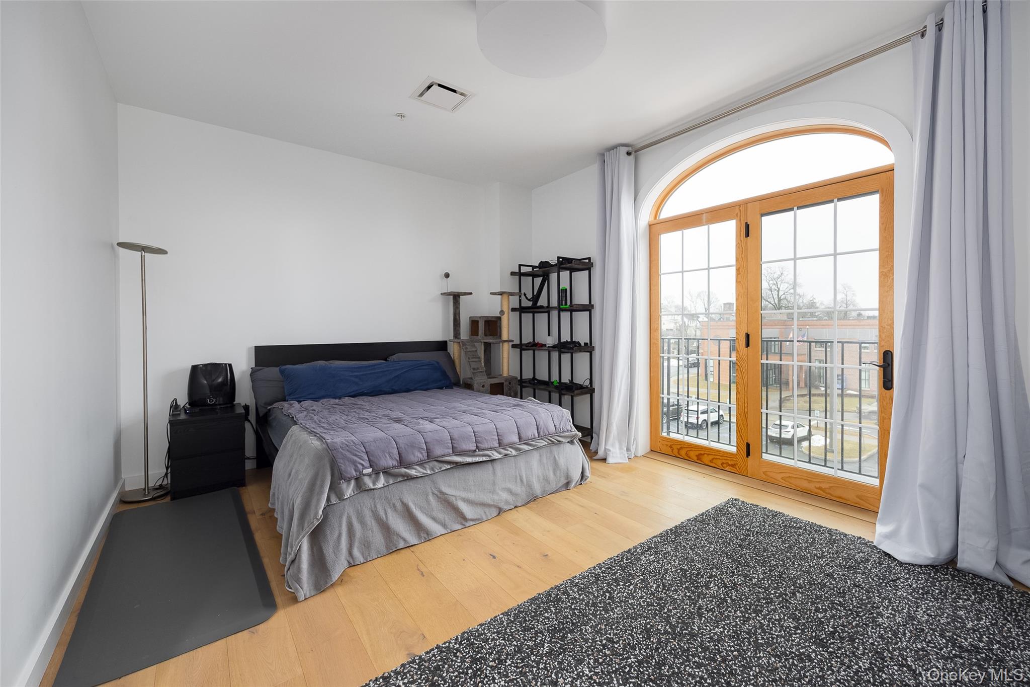 249 Main Street, Unit 312 Beacon, NY 12508 - Photo 9 of 23 a bedroom with a large bed and a large window