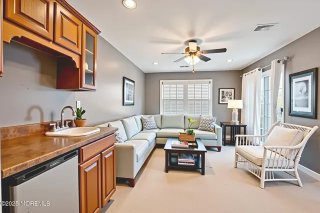 a living room with furniture a couch and a chandelier