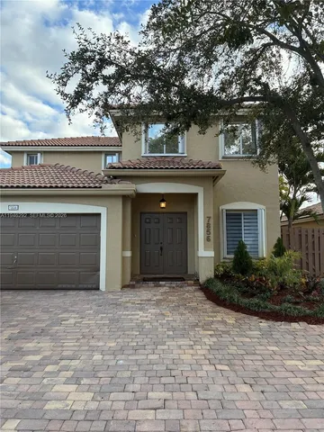 a view of a house with a garden and plants
