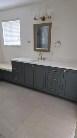 a bathroom with a double vanity sink and mirror