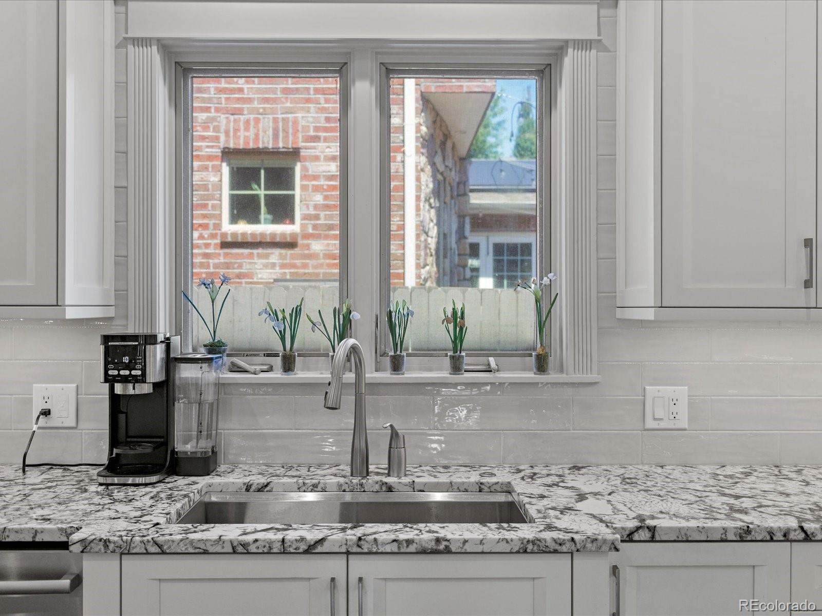 718 North Locust Street Denver, CO 80220 - Photo 13 of 46 a kitchen with granite countertop a sink and a window