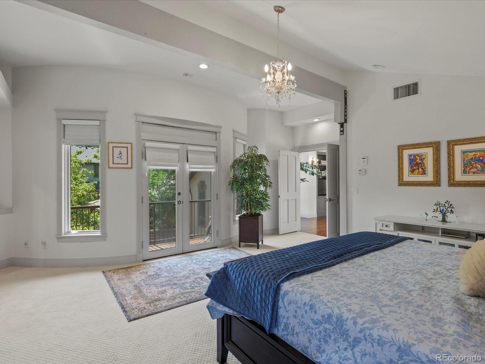 718 North Locust Street Denver, CO 80220 - Photo 21 of 46 a bedroom with a large bed and large windows