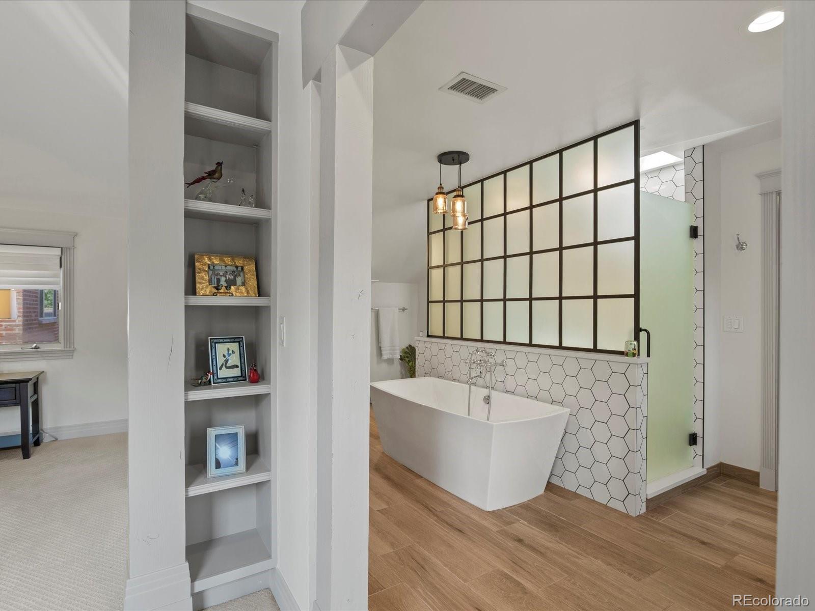 718 North Locust Street Denver, CO 80220 - Photo 22 of 46 a bathroom with a bathtub and a shower