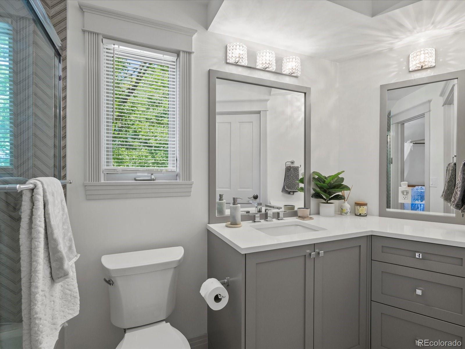 718 North Locust Street Denver, CO 80220 - Photo 28 of 46 a bathroom with a toilet sink and mirror