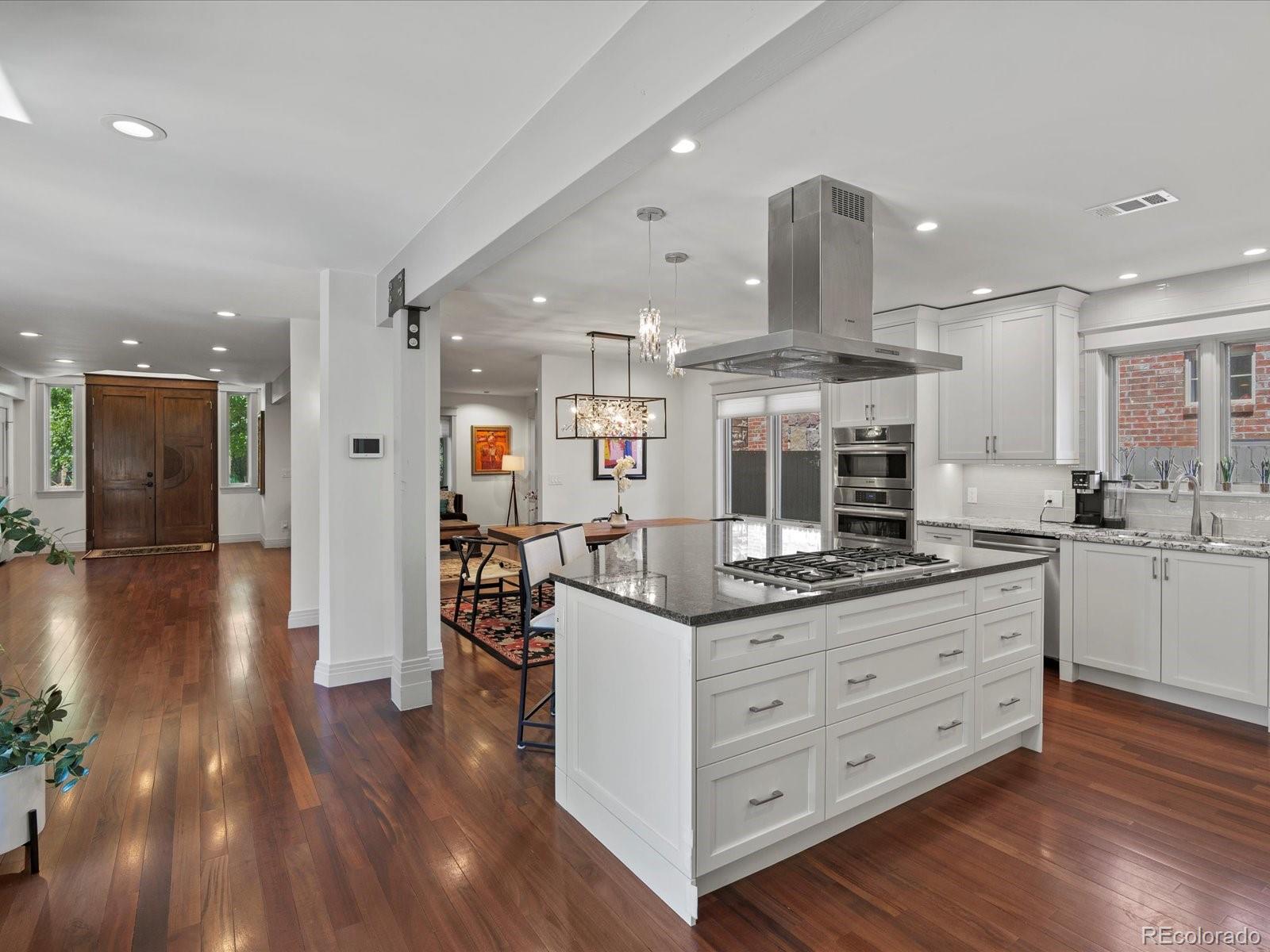 718 North Locust Street Denver, CO 80220 - Photo 9 of 46 a kitchen with stainless steel appliances granite countertop a stove and a wooden floors