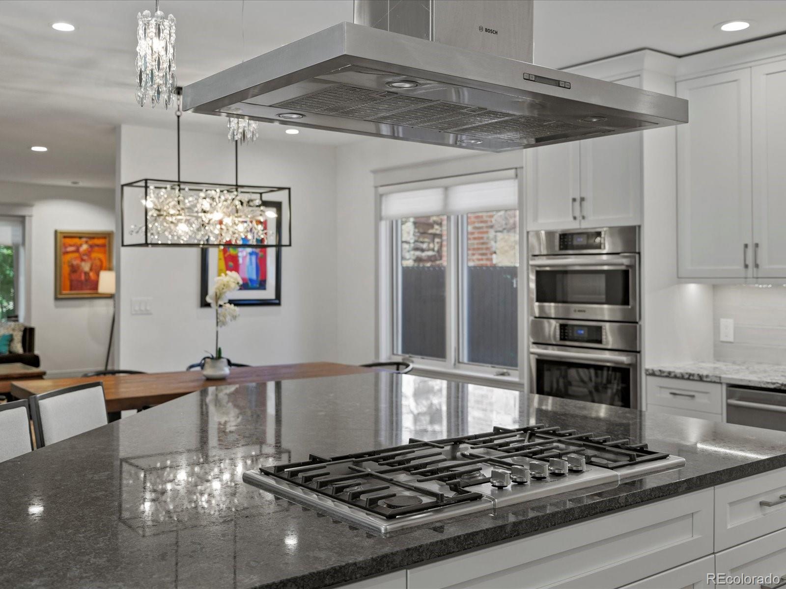 718 North Locust Street Denver, CO 80220 - Photo 10 of 46 a kitchen with stainless steel appliances granite countertop a stove and a refrigerator