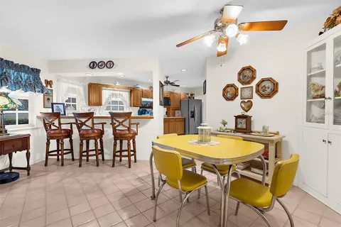 a view of a dining room with furniture and chandelier