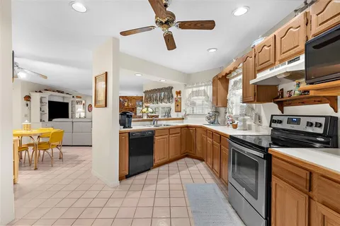 a kitchen with stainless steel appliances kitchen island granite countertop a sink counter space cabinets and stainless steel appliances