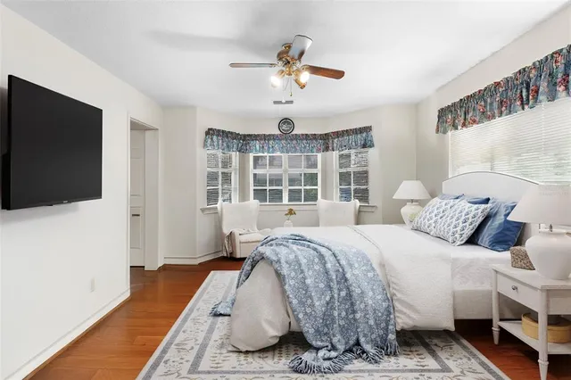 a spacious bedroom with a bed and a large window