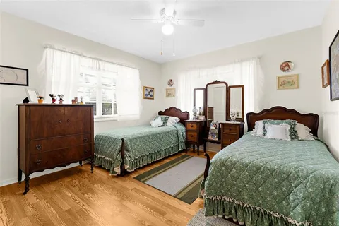 a bedroom with two beds and window