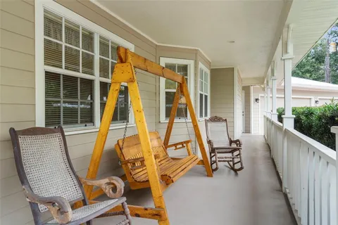 a view of a chair and tables in the balcony
