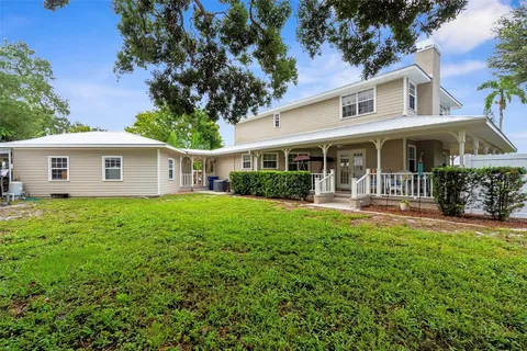 a view of house with a yard
