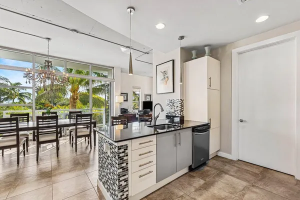 a kitchen with stainless steel appliances kitchen island granite countertop a refrigerator and a stove top oven