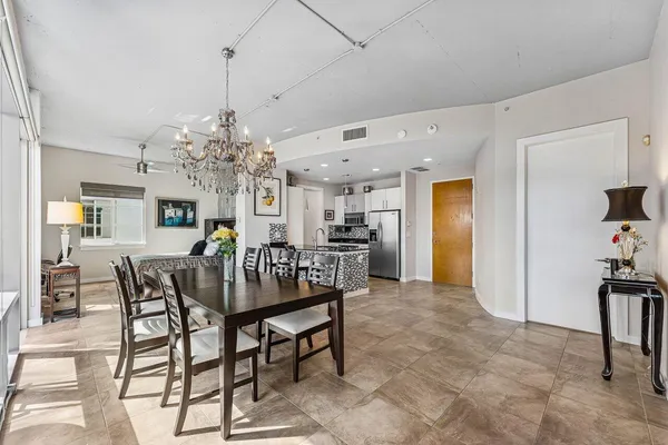 a view of a dining room with furniture and chandelier