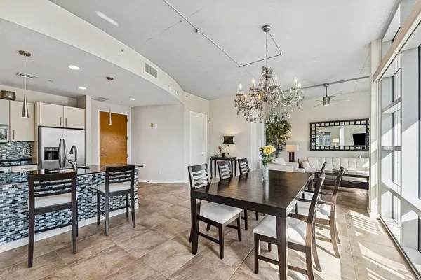 a view of a dining room with furniture and chandelier