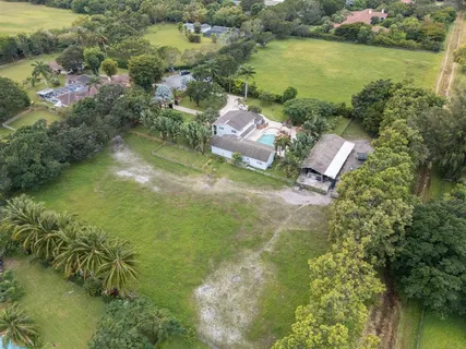 a front view of a house with a yard and a garage