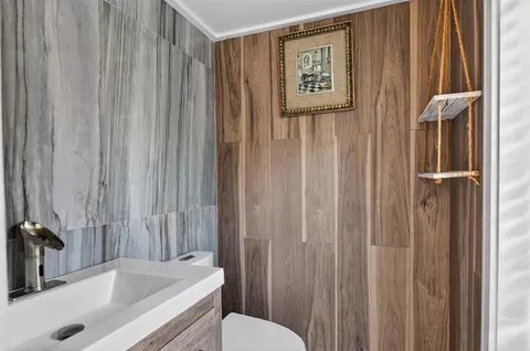 a bathroom with a tub a toilet and a sink