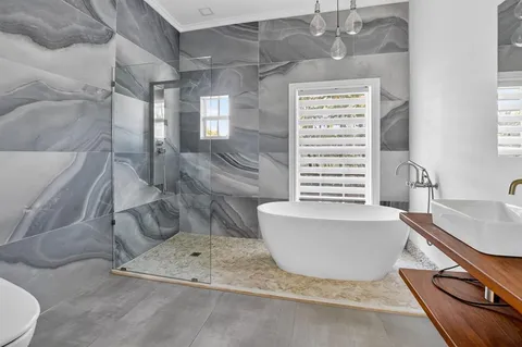 a view of a swimming pool with lounge chairs