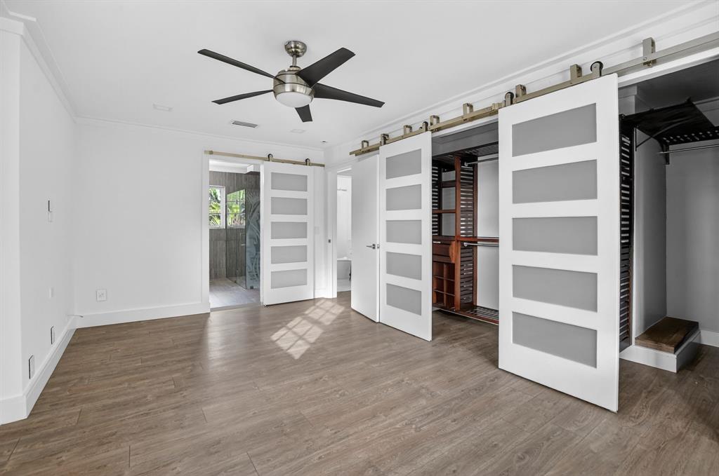 8233 Stagecoach Lane Boca Raton, FL 33496 - Photo 46 of 88 a view of an empty room with a window and wooden floor