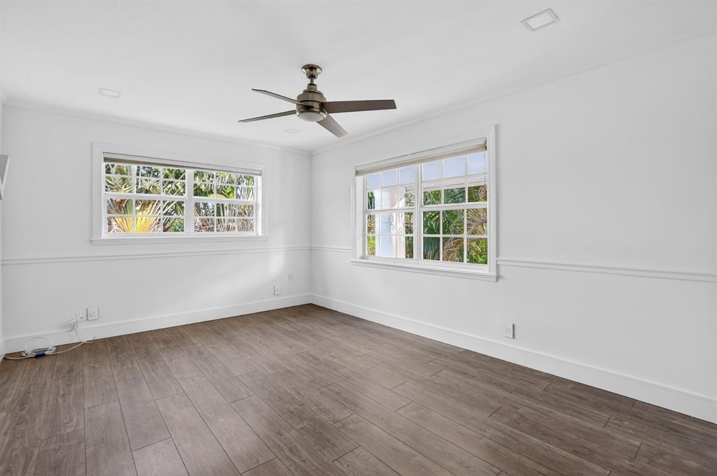 8233 Stagecoach Lane Boca Raton, FL 33496 - Photo 55 of 88 a view of an empty room with wooden floor and a window