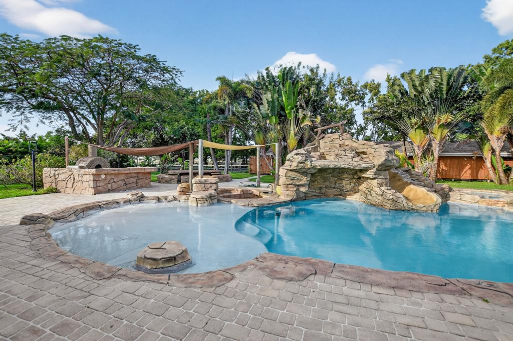 8233 Stagecoach Lane Boca Raton, FL 33496 - Photo 66 of 88 a view of a swimming pool with lounge chairs
