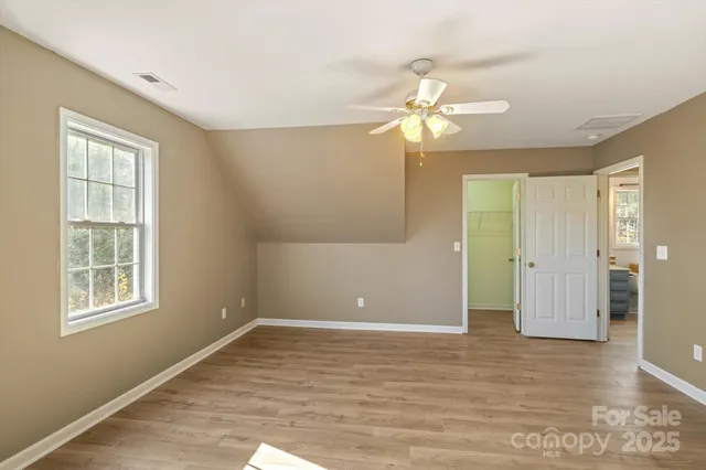 a bedroom with a bed and a mirror