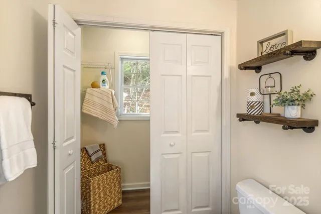 a bathroom with a toilet a sink and mirror