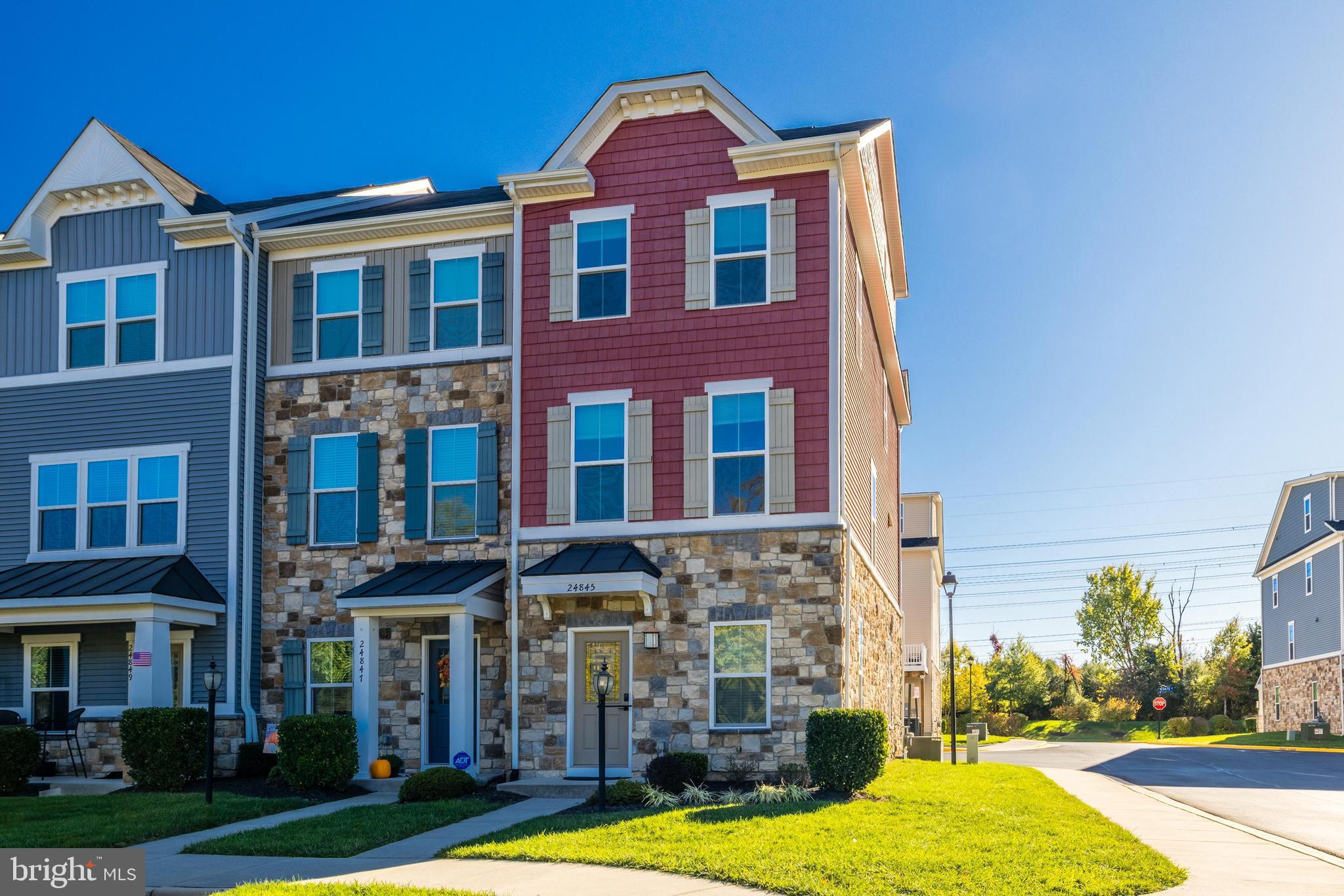 a front view of a building with yard and windows