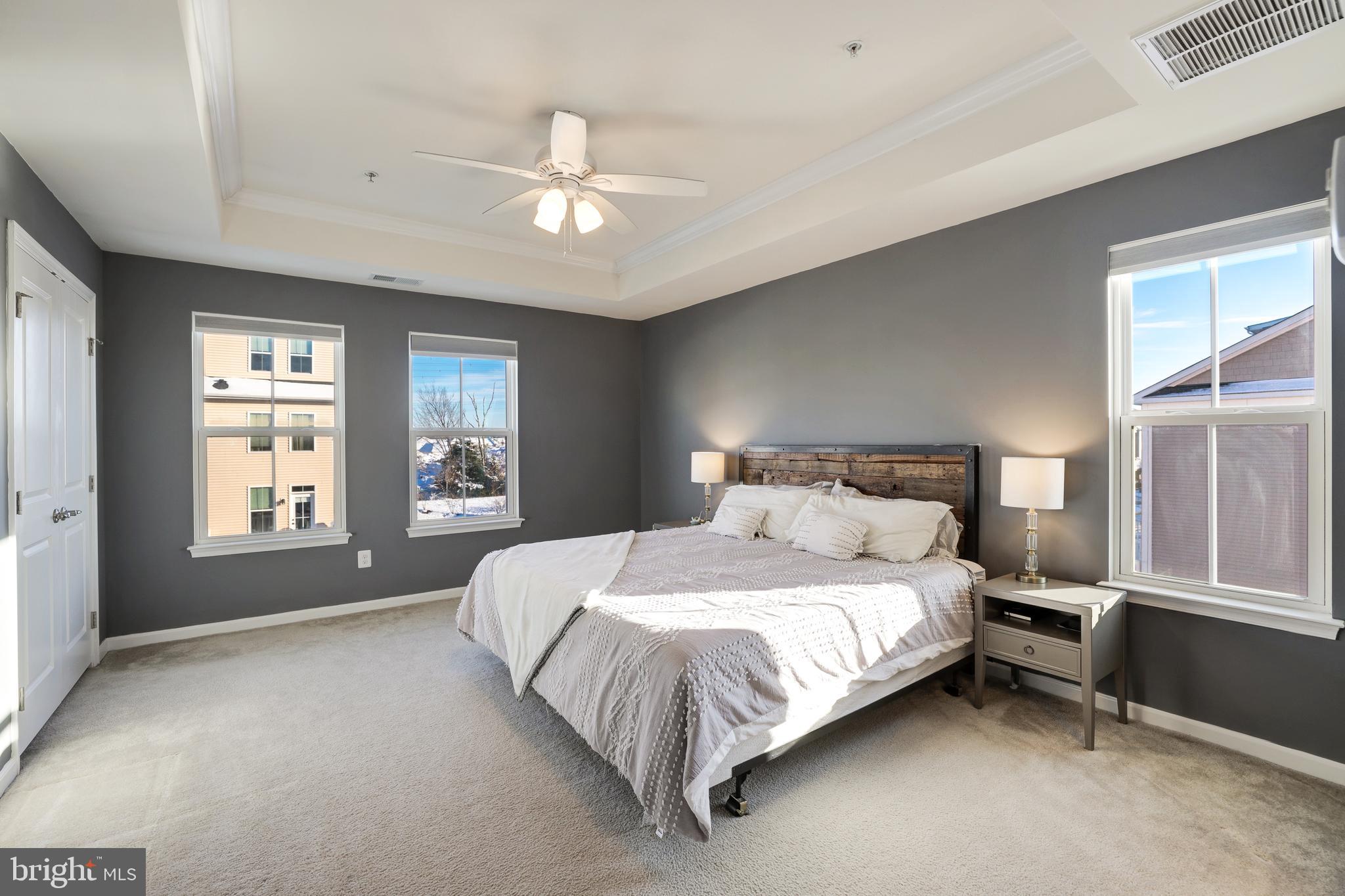 24845 Coats Square Aldie, VA 20105 - Photo 25 of 40 a large bed sitting in a bedroom next to a window and a chandelier