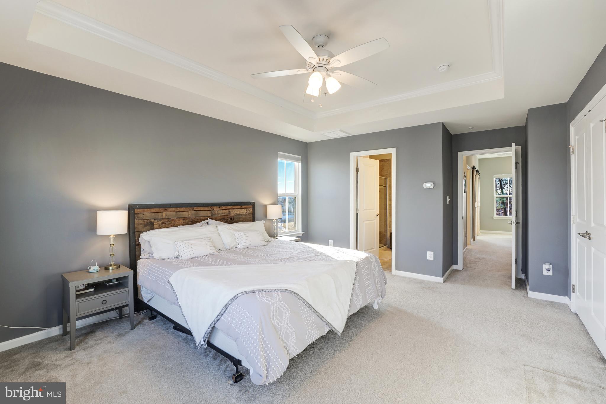 24845 Coats Square Aldie, VA 20105 - Photo 27 of 40 a bedroom with a large bed and a chandelier
