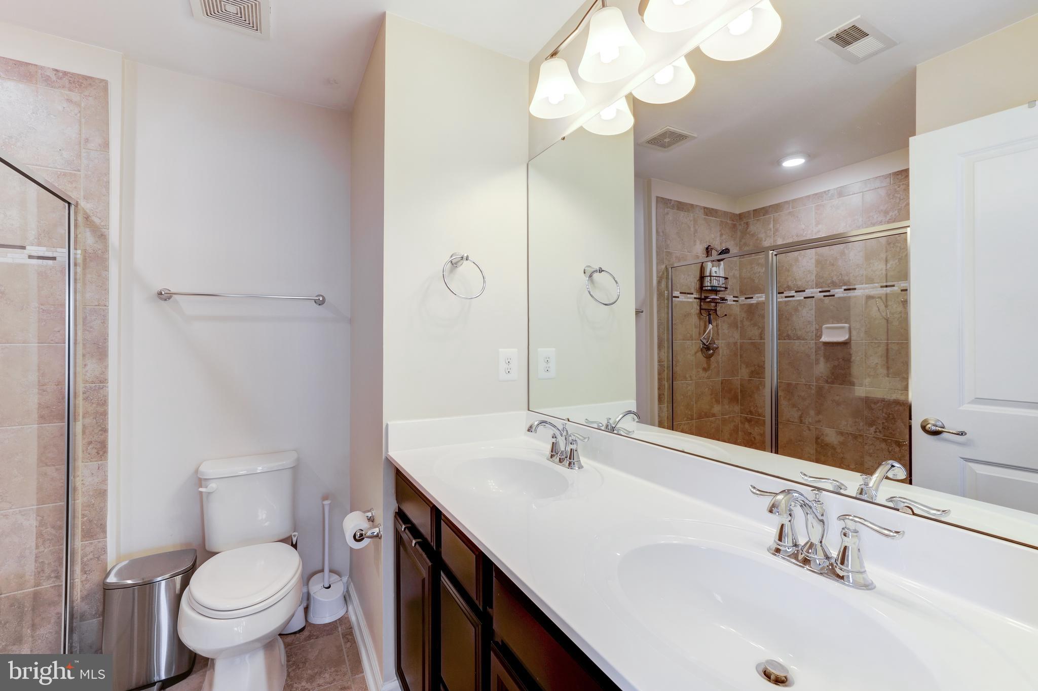 24845 Coats Square Aldie, VA 20105 - Photo 28 of 40 a bathroom with a sink a toilet and a mirror