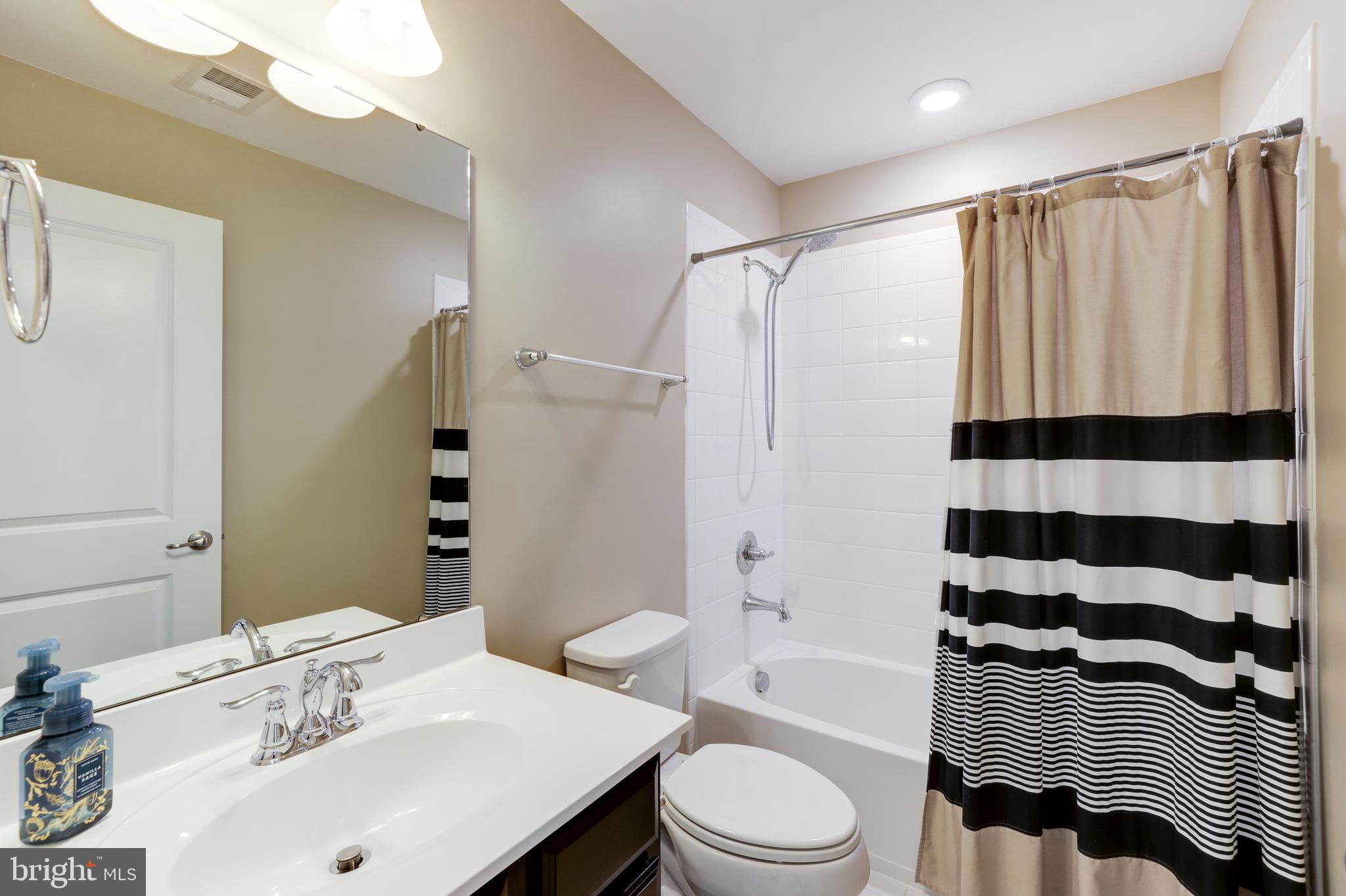 24845 Coats Square Aldie, VA 20105 - Photo 30 of 40 a bathroom with a sink a toilet a mirror and shower