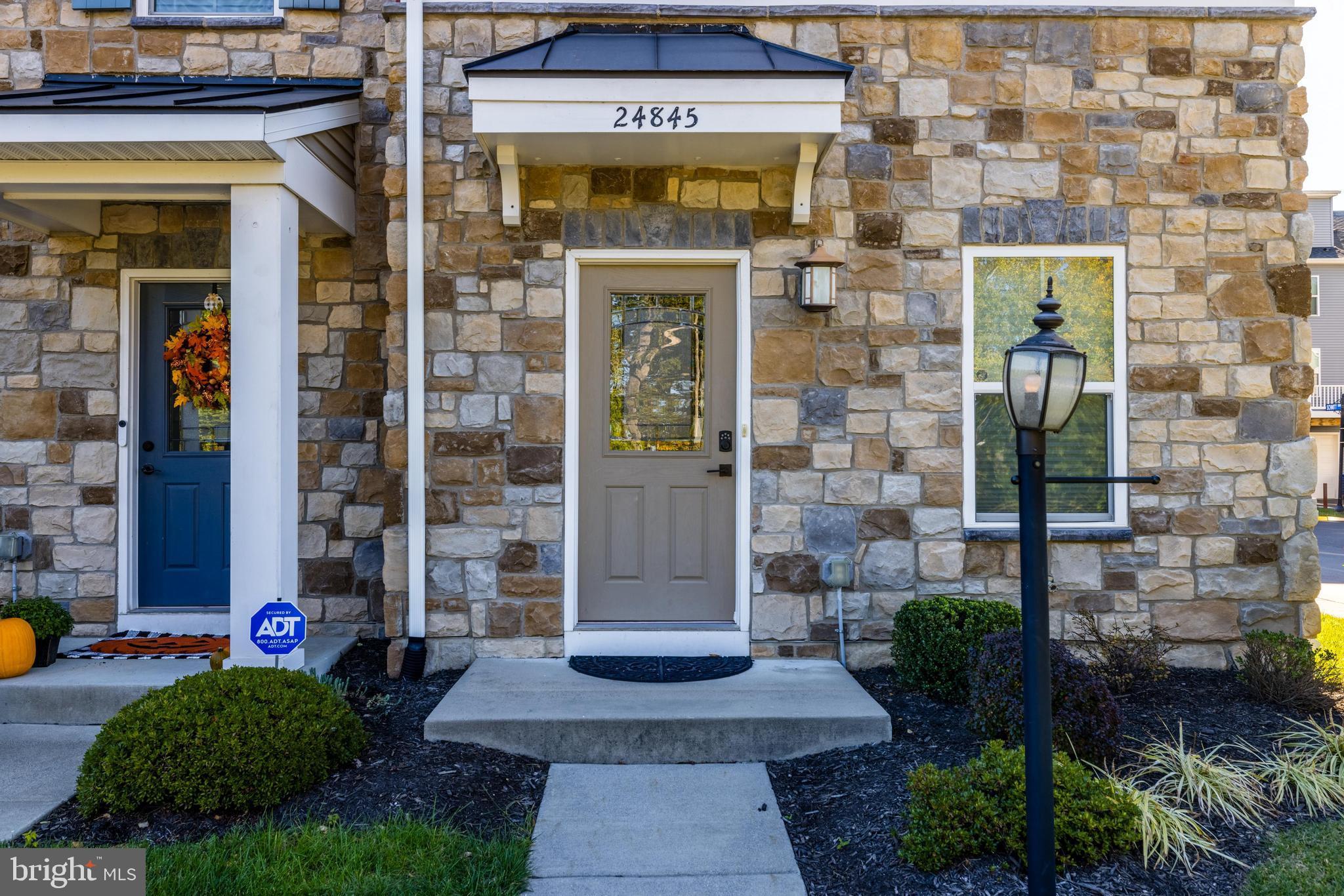 24845 Coats Square Aldie, VA 20105 - Photo 4 of 40 a front view of a building with a garden