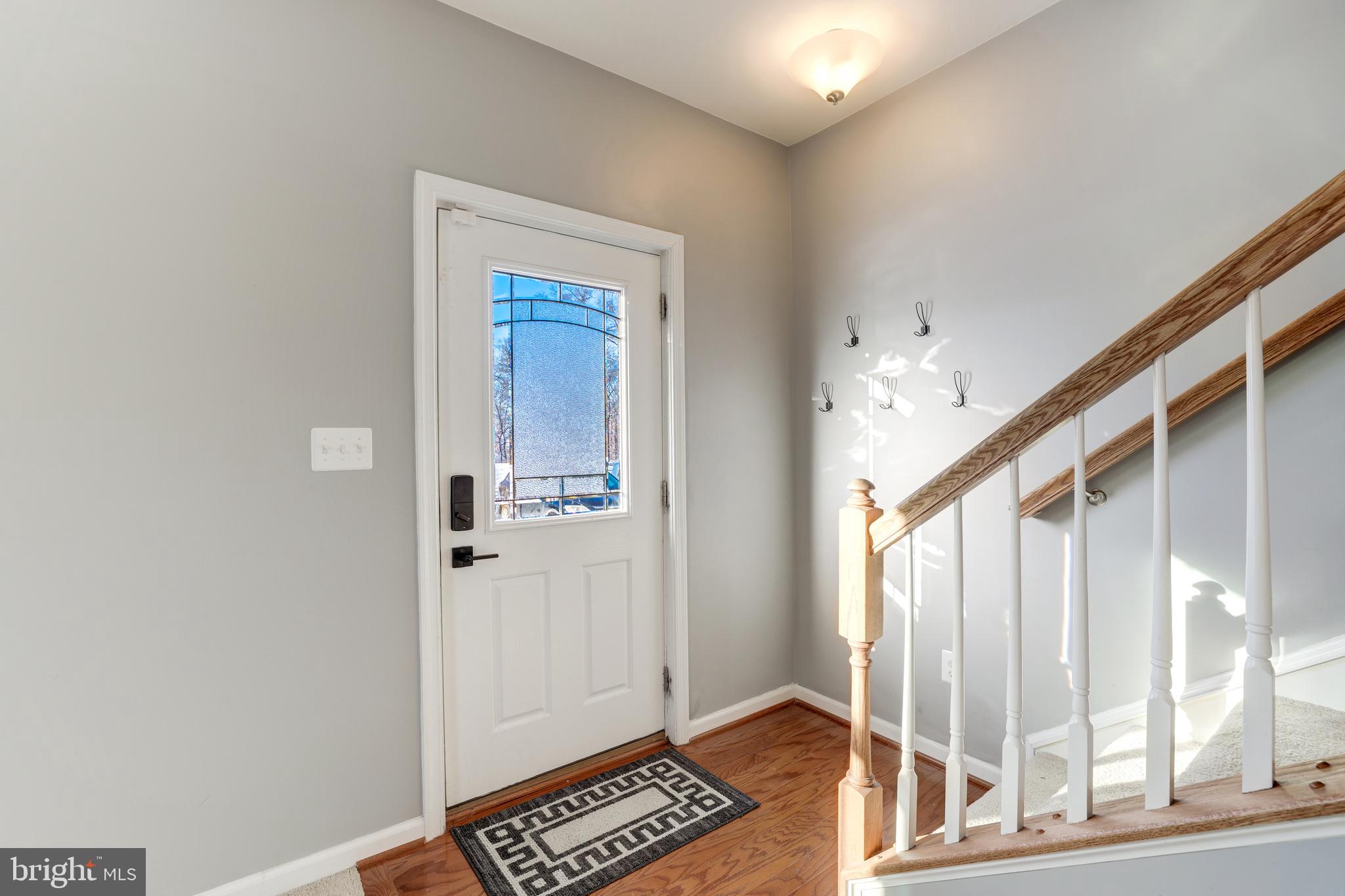 24845 Coats Square Aldie, VA 20105 - Photo 9 of 40 a view of front door with wooden floor