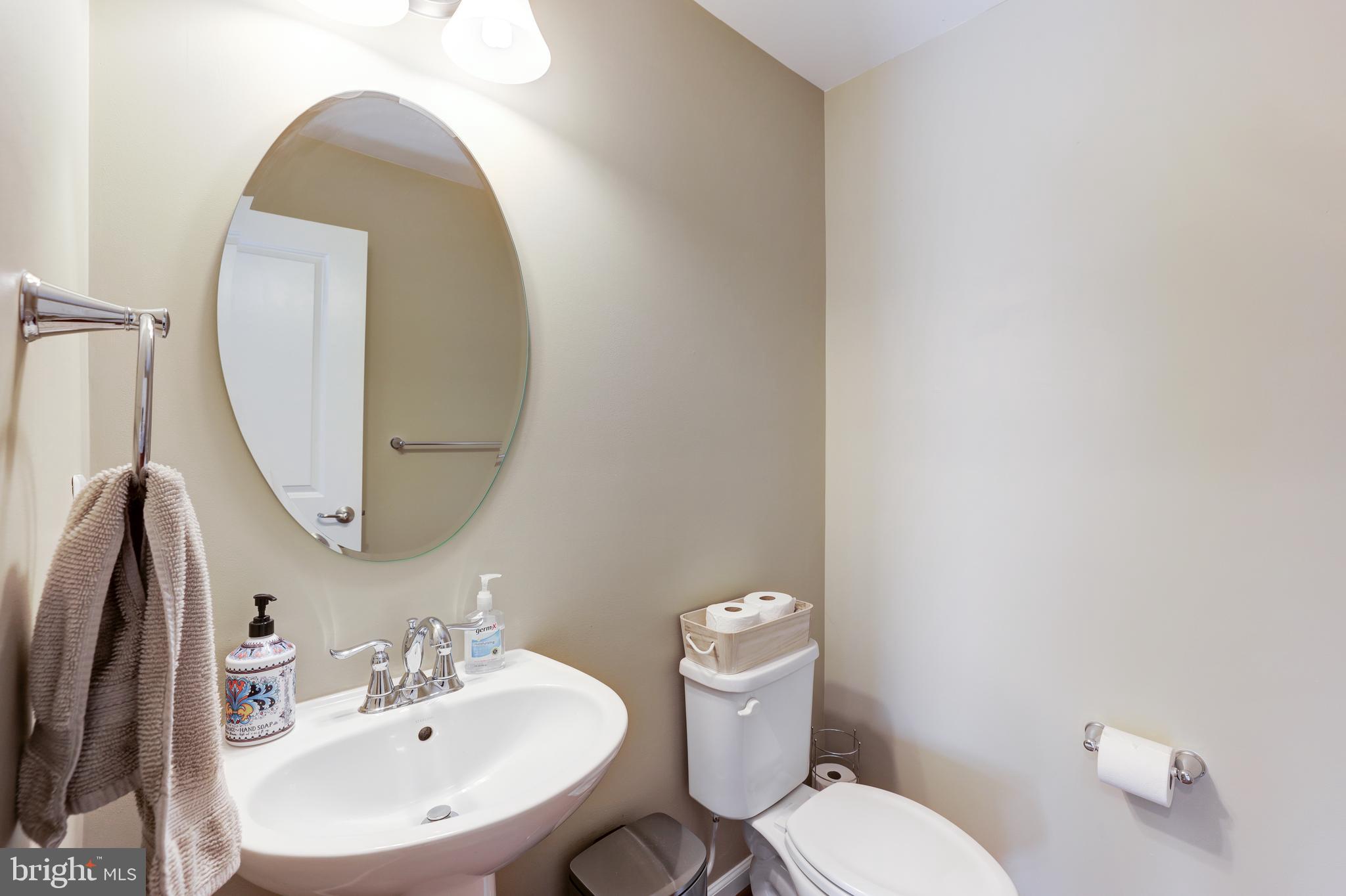 24845 Coats Square Aldie, VA 20105 - Photo 10 of 40 a bathroom with a toilet sink and mirror