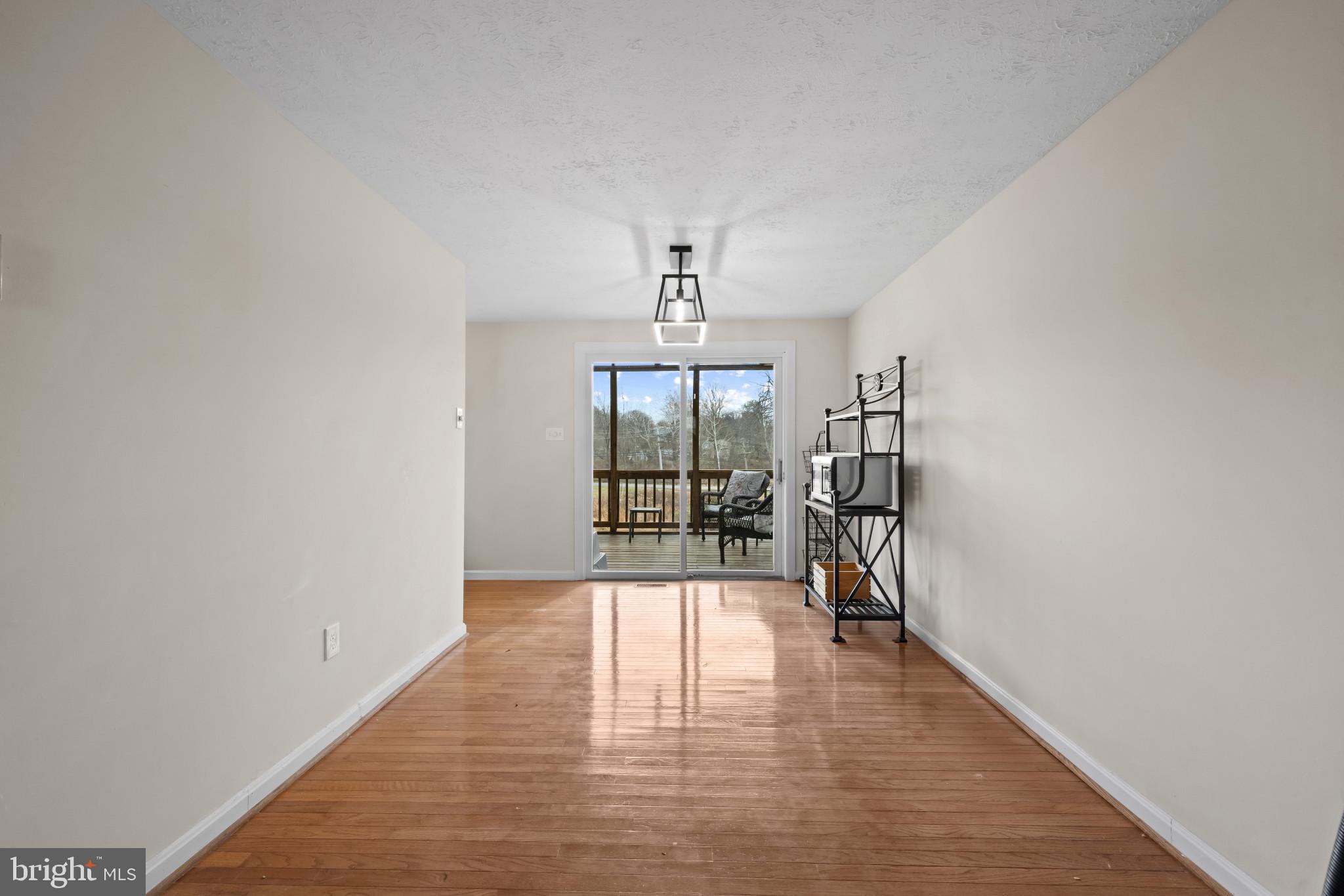 9281 Pigeon Wing Place Columbia, MD 21045 - Photo 14 of 55 a view of empty room with wooden floor